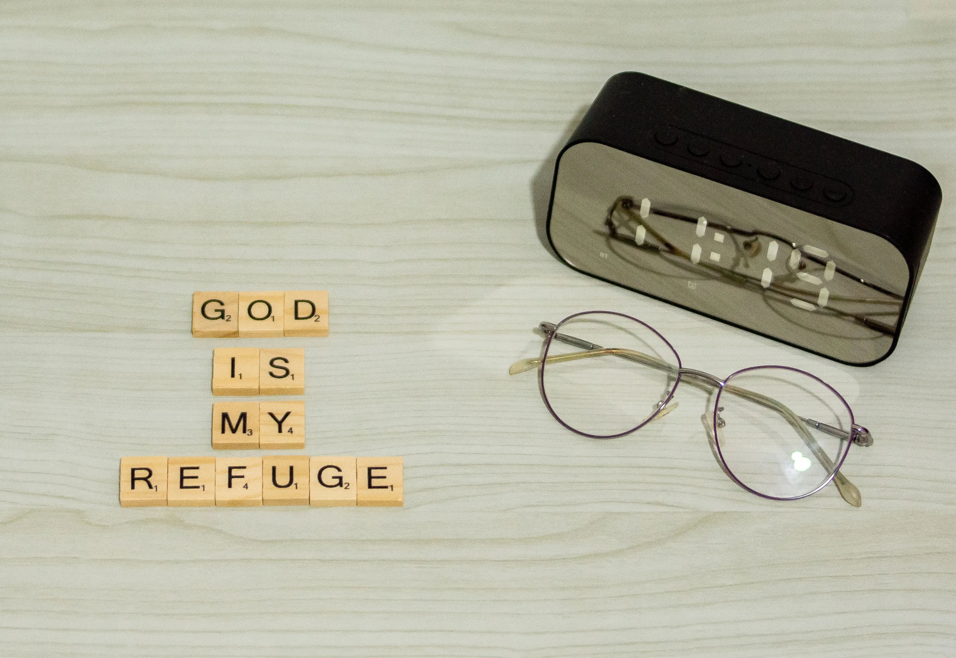 The letters spell out 'God is my refuge.' in Scrabble.